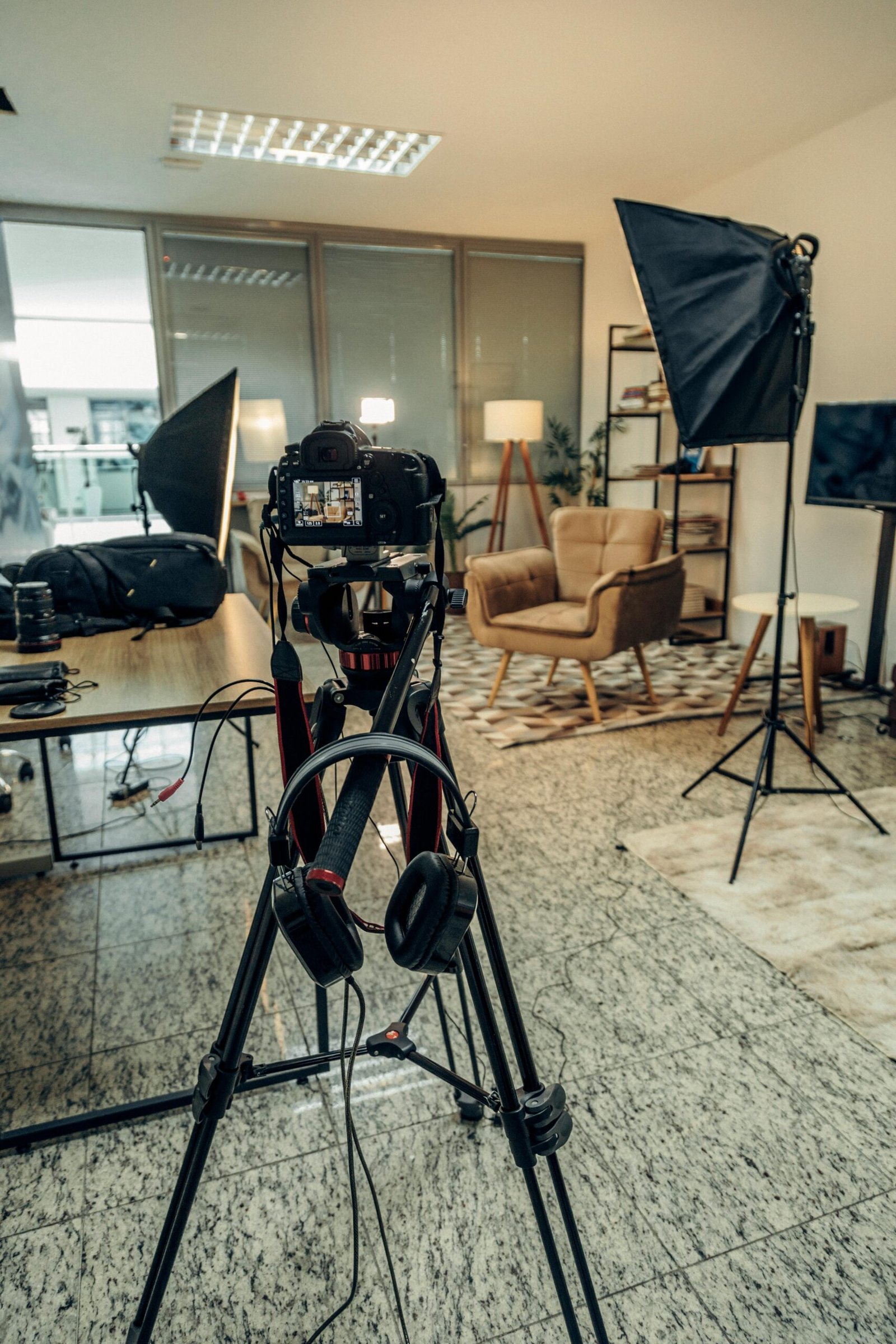 An indoor professional photography studio setup with camera and lighting equipment ready for a photoshoot.